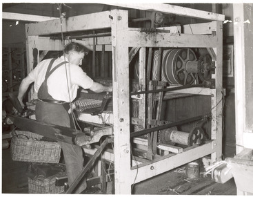 Man operating mat making machine