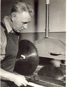 Male using a band saw in a workshop