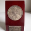 1 maroon wooden stand with gold tone inlaid medallion, with illustrations