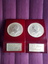 Two gold toned medals inset maroon wooden blocks with '35 Year Award' on base