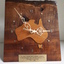 Wooden base with clockface in shape of Australia and plaque beneath