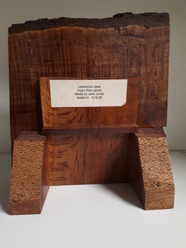 Rear of wooden clock with stand and sticker