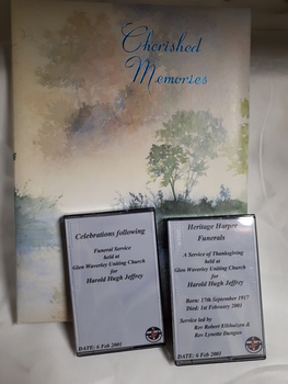 Folder with title 'Cherished memories' and 2 cassettes