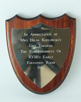 Wooden shield with metal plate attached
