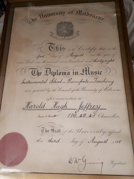 Framed diploma with black writing and red seal