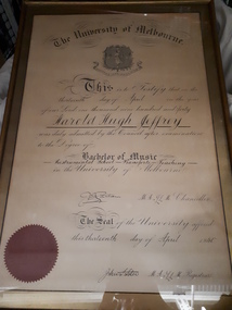Framed certificate with black writing and red seal