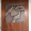 Two hands holding grid with third hand putting missing piece back.