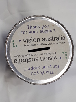 Metal tin with gap in lid and sticker on top