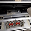 Silver case and keyboard with red, tan and black buttons inside black briefcase