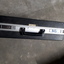 Silver case and keyboard with red, tan and black buttons inside black briefcase