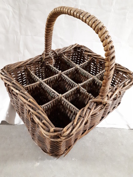 Cane basket with handle and dividers to carry milk bottles
