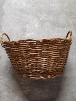 Cane oval basket with cane handles at either end