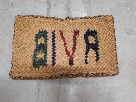 Reverse of printed bristle floor mat made by RVIB workers