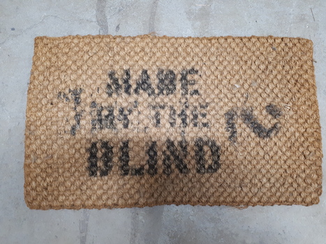 Reverse of printed bristle floor mat made by RVIB workers