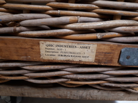 Close up of QBIC Industries sticker on basket