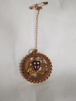Australia coat of arms inside circle with engraving around edge
