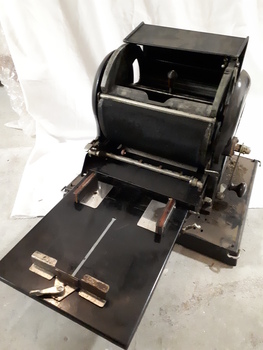 Machine opened up with paper feed and rotary barrel shown