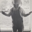 Young boy standing in front of large window