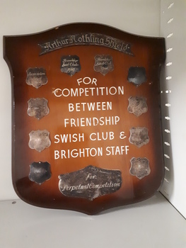 Wooden shield with metal plates and white writing