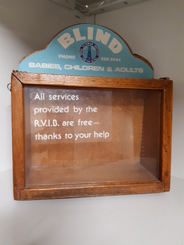 Wooden rectangle with plastic side and sign