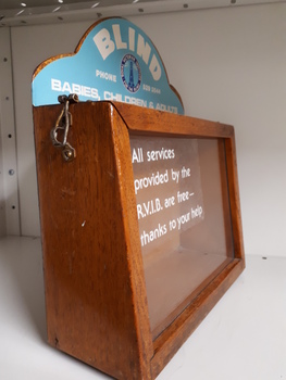 Wooden rectangle with plastic side and sign