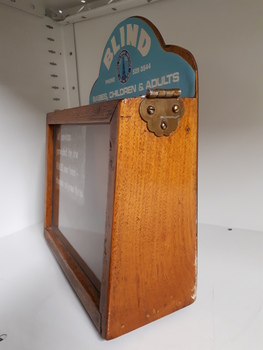 Wooden rectangle with plastic side and sign