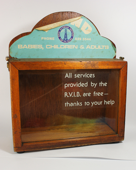 Wooden rectangle with plastic side and sign