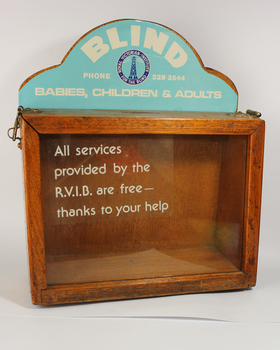 Wooden rectangle with plastic side and sign