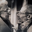 An elderly female and older man face each other.