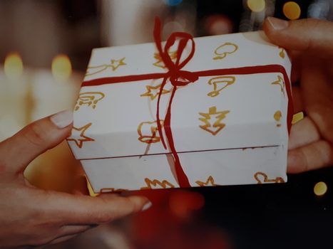 A Christmas gift exchanges hands