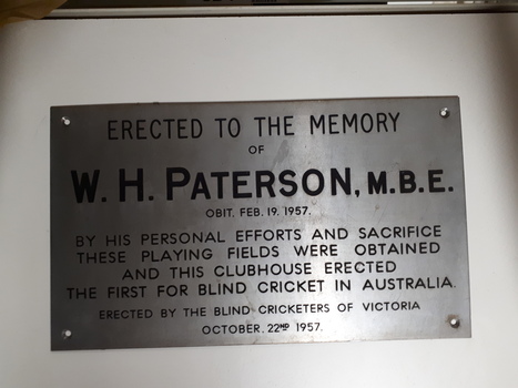 Silver plaque with black writing
