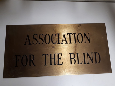 Bronze coloured plaque inscribed with Association for the Blind