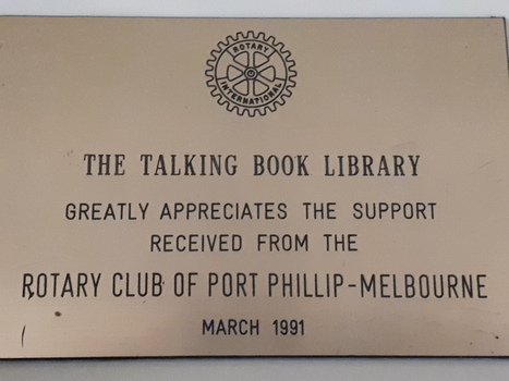 Bronze coloured plaque with Rotary symbol at the top