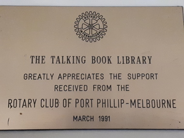 Bronze coloured plaque with Rotary symbol at the top