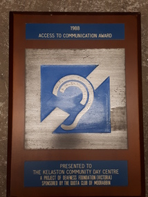 Blue and silver plaque with illustration of ear with a large line across it