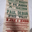 Rectangular paper with red, green and blue lettering