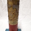 Metal cylindrical map with tactile markers showing Pacific Ocean