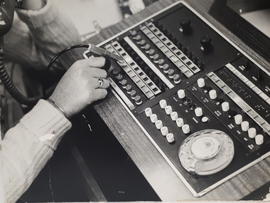 View of a switchboard located on a desk, used by a female.