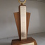 Wooden award with gold coloured plates and two hands clasped amongst laurels at top