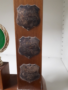 Metal plates on side of trophy