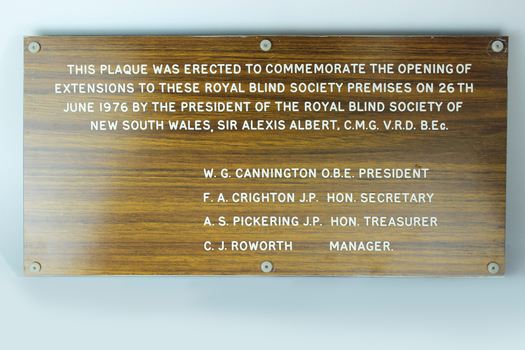 Laminate board with woodgrain finish and etched white lettering