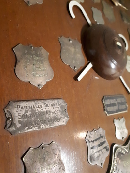 Close up of silver plates on wooden shield