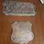 Close up of silver plate shield on wooden shield