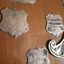 Wooden shield with smaller silver plates engraved with winner names and round wooden ball top in middle with two mini white canes