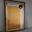 Laminate board with golden and silver coloured engraved sheet attached