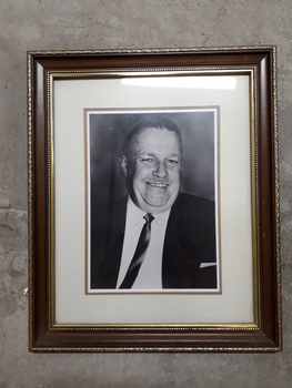 Smiling man in suit and thin tie facing the camera