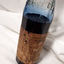 Glass bottle with ink and paper label "Made by the Blind"