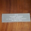 Close up of metal plaque on wooden shield