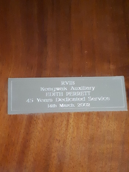 Close up of metal plaque on wooden shield