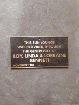 Brown plaque with raised copper letters